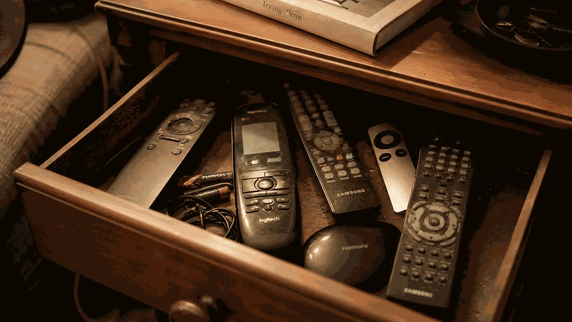 Logitech Harmony remotes stored in a drawer